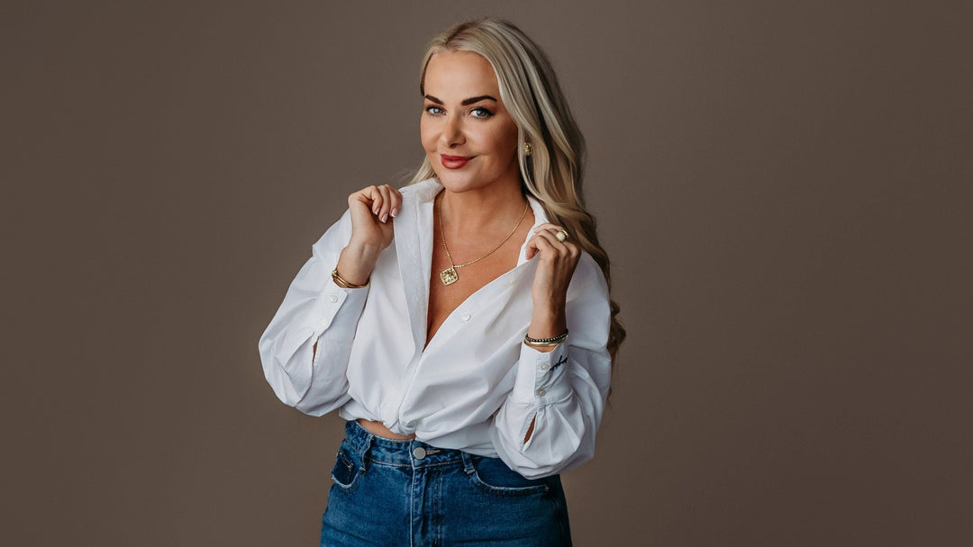 Woman in white shirt wears classic gold jewelry