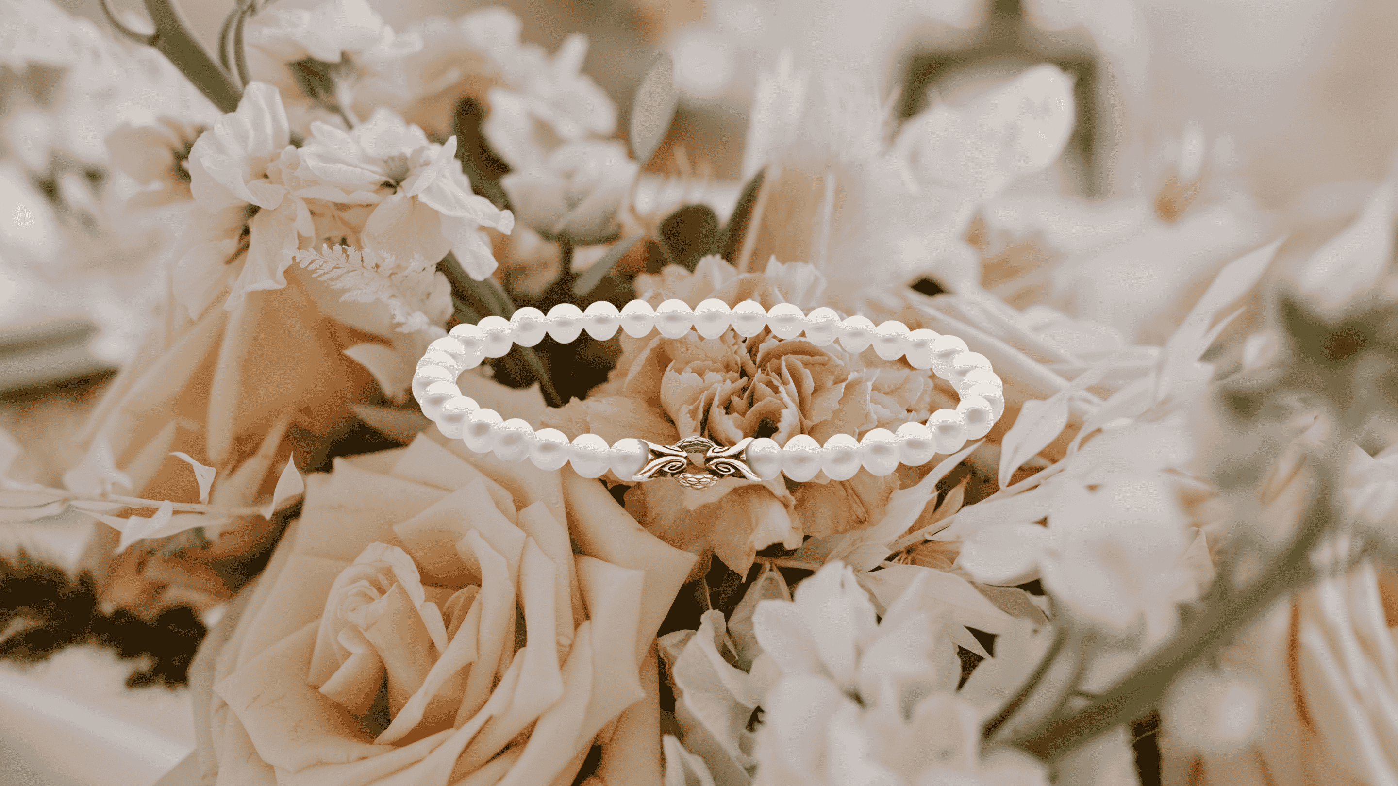 Pastel floral background with REALM Bond Bracelet — Mother's Day jewelry gifts.