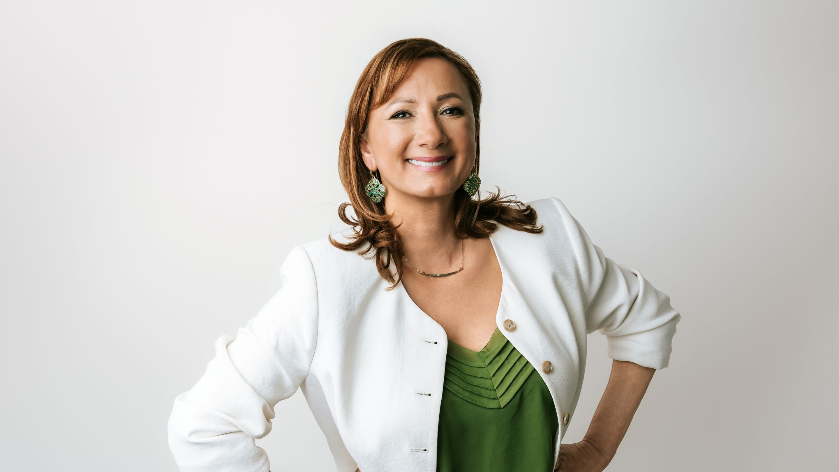 Stella Ludwig in green blazer wearing REALM CZ Vert jewelry — Real Woman of REALM.