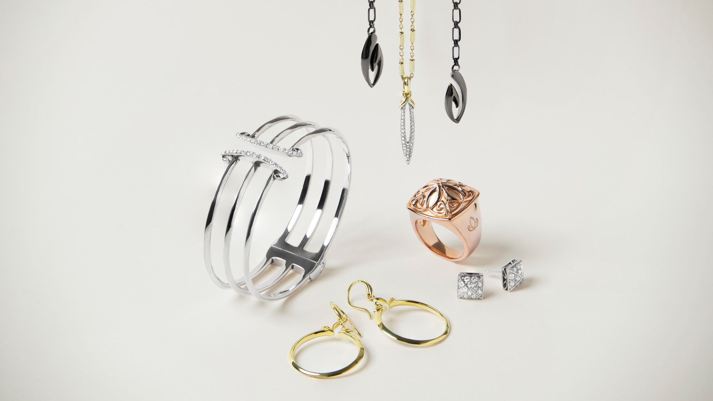 Array of gold, rose gold and silver jewelry from REALM