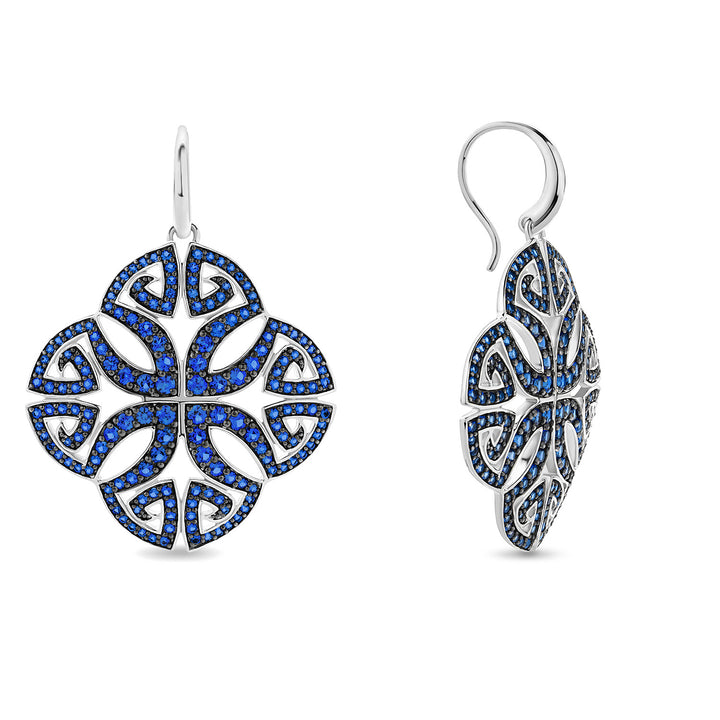 Pair of earrings with blue gemstones on a white background