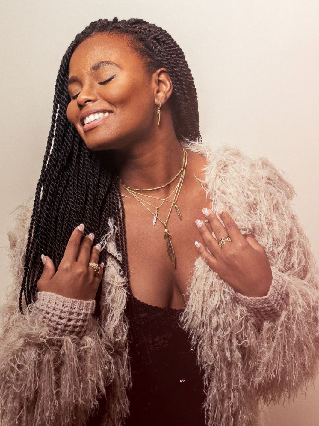 Fran shows off a rock star vibe with shaggy coat and layered necklaces from REALM Fine + Fashion Jewelry