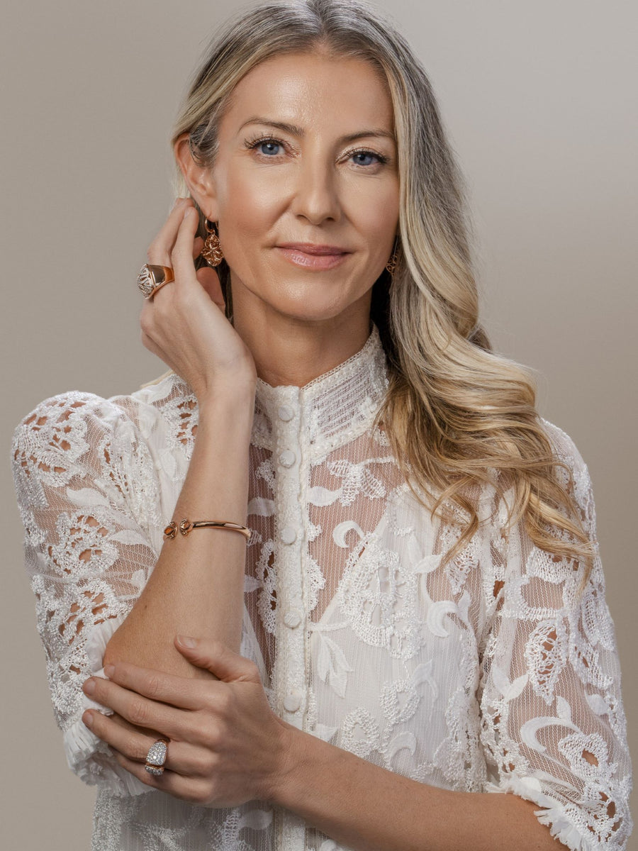 Luxury Realtor Kristin Daly wears romantic rose gold jewelry from REALM