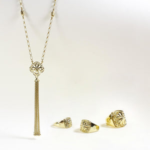 Gold tassel necklace and trio of gold signet rings from the INSIGNIA Collection by REALM