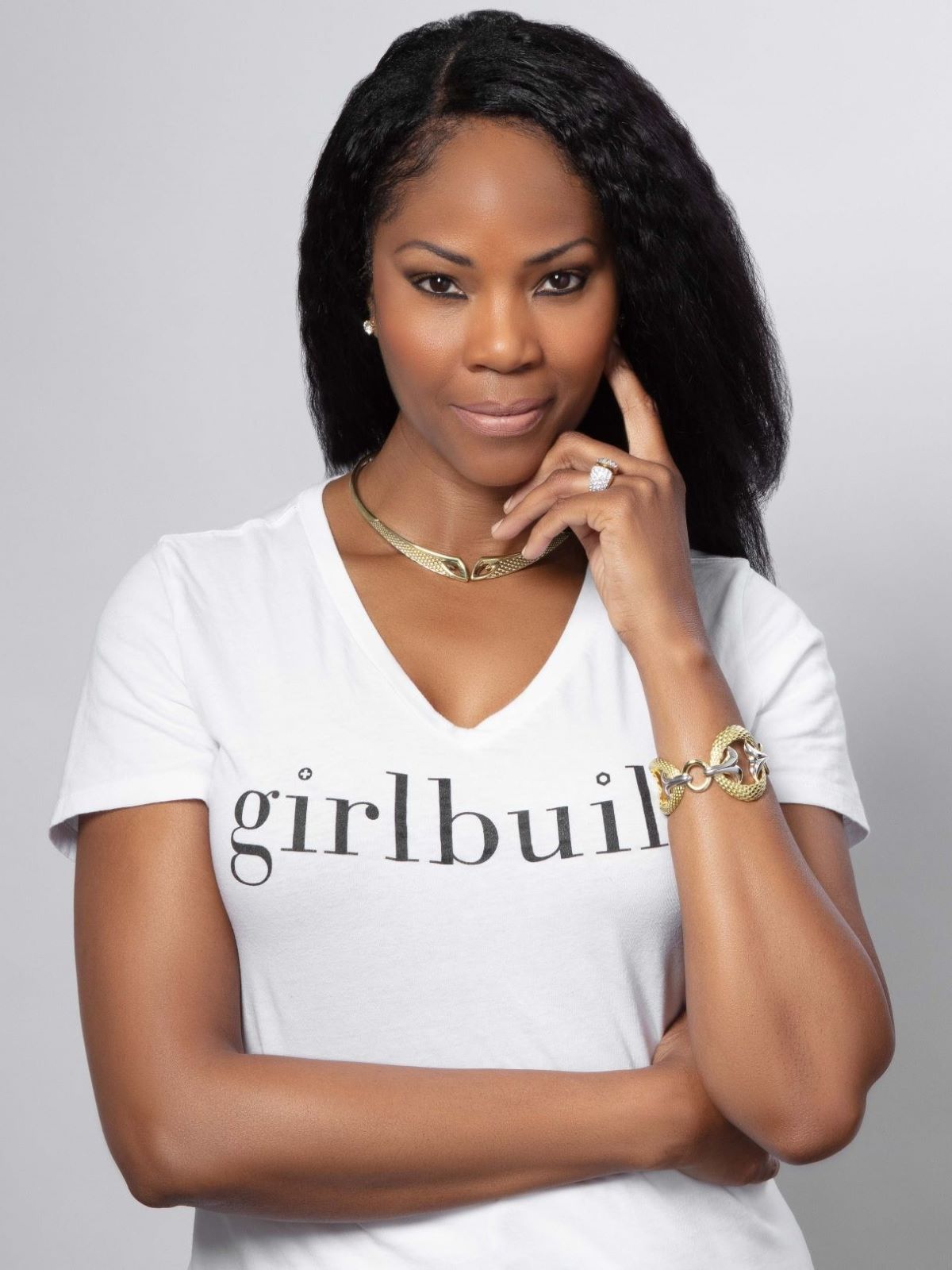 Monica Miraglilo, founder of GirlBuild wears REALM gold jewelry with a white Tee - portrait