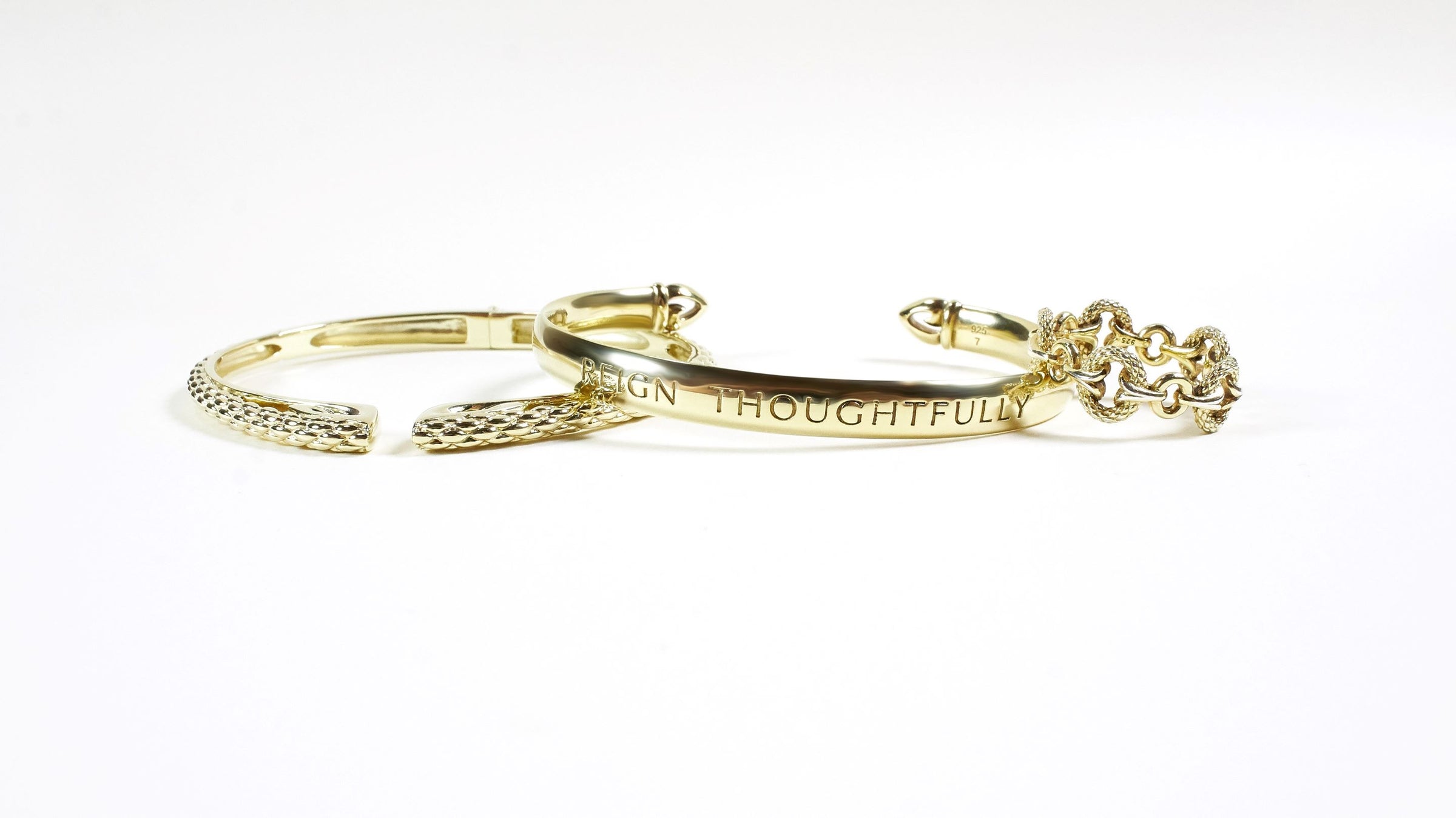 Trio of gold python bracelet, gold cuff engraved with "Reign Thoughtfully" message and gold ring