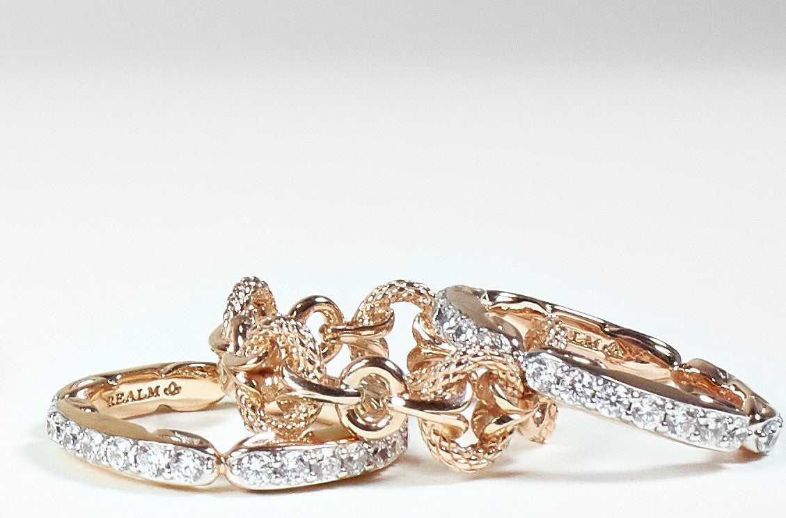 trio of rings in 18K-rose-gold and white cz pave from REALM Fine + Fashion Jewelry