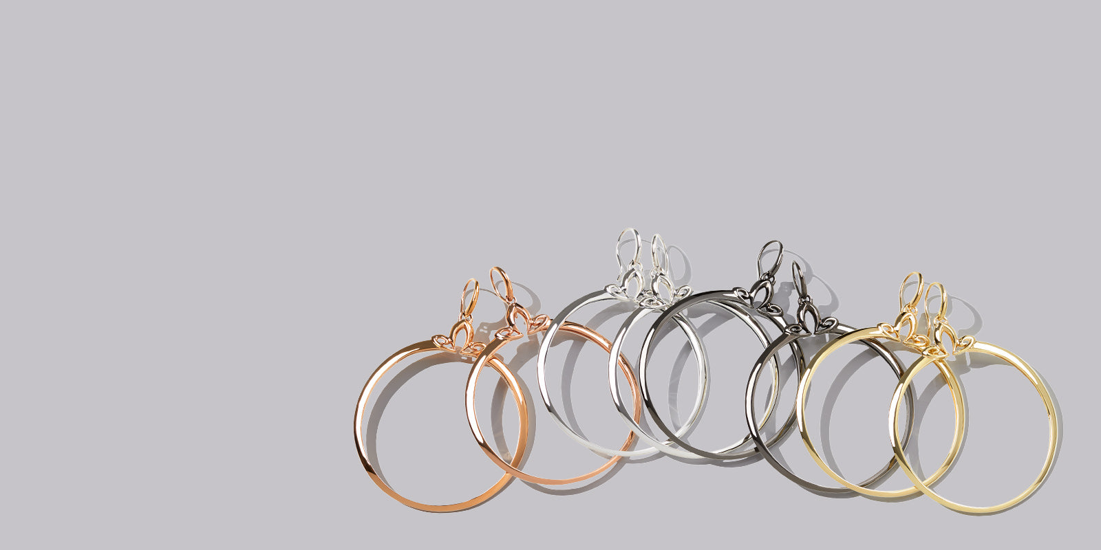 four DOMAIN portrait hoop earrings in The Shades of REALM precious metal colorways